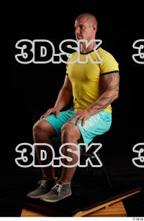 Sitting reference of whole yellow shirt turquoise shorts brown shoes…